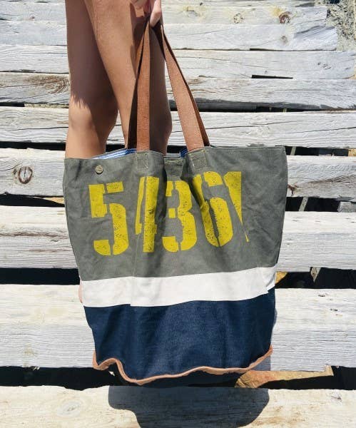 KOBE SNR4 tote-taske med gult 54361-print og mørkeblå bund ved en trætrappe